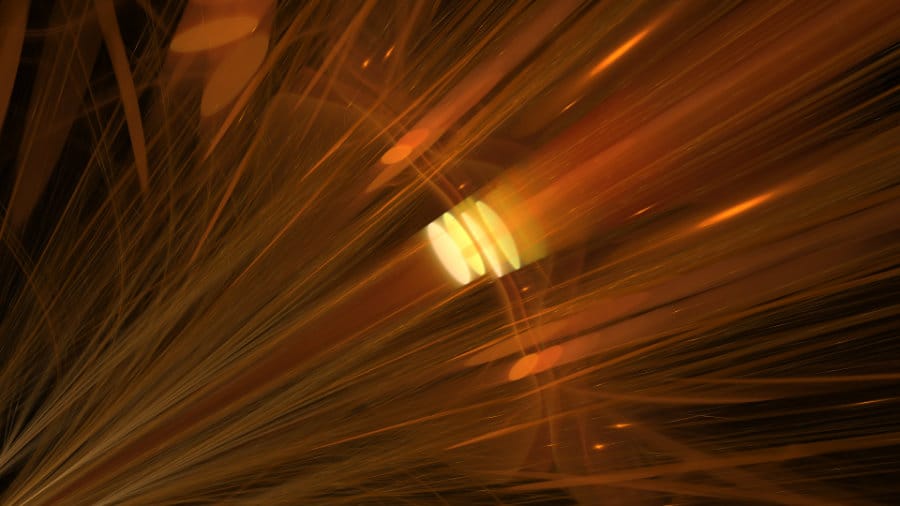 A dynamic abstract image with amber and gold tones. Bright, thin lines streak diagonally from the bottom-left, resembling fiber optics or light rays. A central glowing ellipse is surrounded by soft bokeh circles.